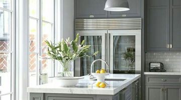 A beautifully decorated kitchen featuring grey cupboards
