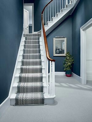 A professionally painted hallway with a staircase
